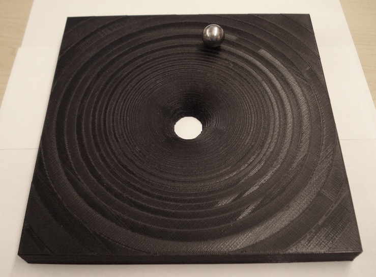 Picture of 20x20x2 cm Gravitational Potential well with metal ball in orbit.
