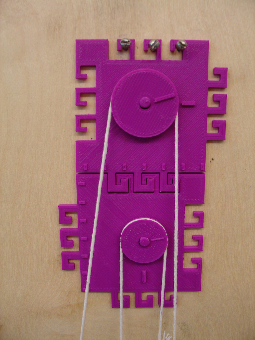 Closeup picture of a three pulley system.